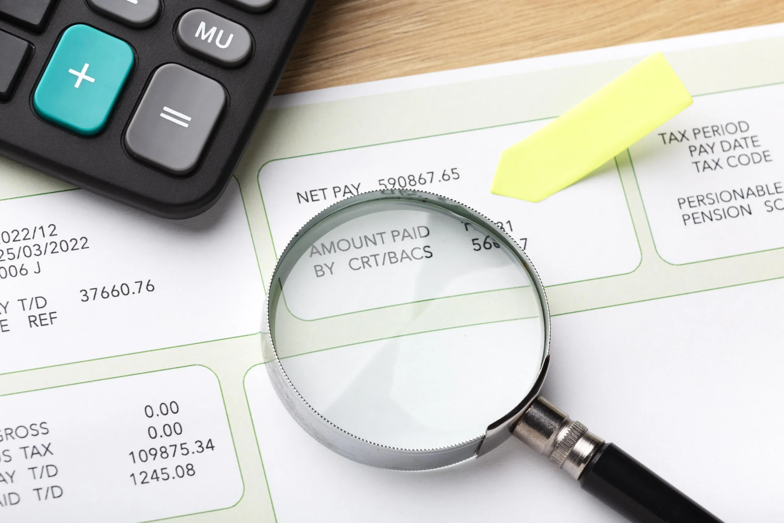payroll still life with magnifying glass